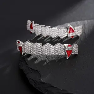 Set of 2 vampire bleeding teeth grills made of shiny cubic synthetic zirconia; includes 8 top and bottom fangs; Halloween hip-hop oral jewelry.