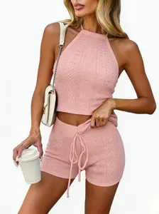 Fashionable women’s casual two-piece set: solid-color sleeveless halter top paired with high-waisted shorts—comfortable vacation outfit with a summer vibe. Openwork beach outfit