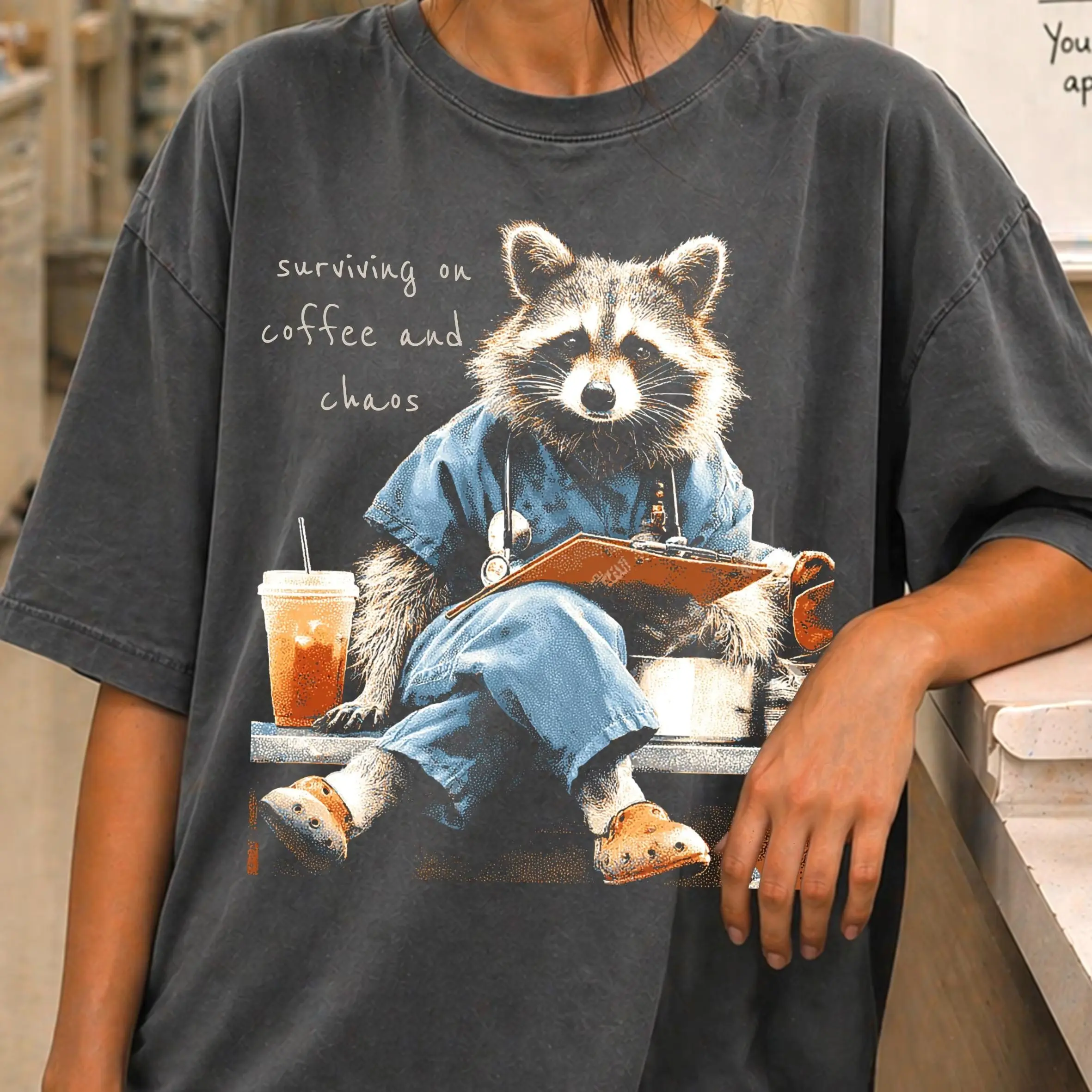 Surviving On Coffee And Chaos Nurse T Shirt, Funny Raccoon Nurse Graphic Tee, Healthcare Worker Gift, RN CNA Medical Assistant Shirt, Nursing Student Gift, Coffee Lover Medical Professional Apparel, Cute Unisex Healthcare Tee