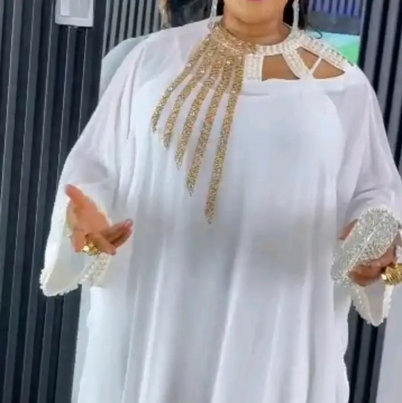 cardi b white and gold dress Cardi B is certainly no stranger to making a major fashion statement, and she completely turned heads while arriving at the Rahul Mishra Paris Fashion Week show! The rapper stepped out in