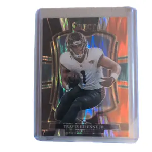 2025 Panini select Travis Etienne Jr premier level Orange and black prism shock