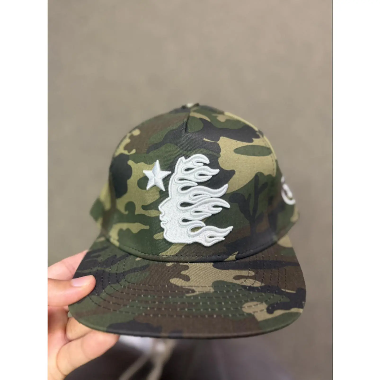 Hellstar Camo Baseball Cap with White Flame Design and Star Detail for Men's Fashion