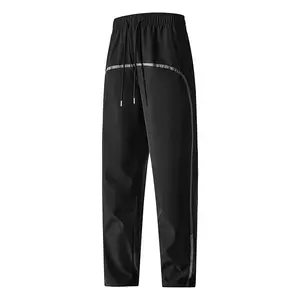 Men’s reflective curved stripe track pants, elastic drawstring waist, quick-dry streetwear trousers, breathable fabric—perfect for casual wear, night style, and everyday use.