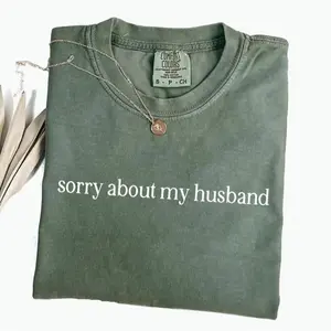 Comfort Colors “Sorry About My Husband” shirt, a sassy sarcastic tee perfect for wives, offering funny humor and a playful twist to any casual outfit. - LORA ATCHER