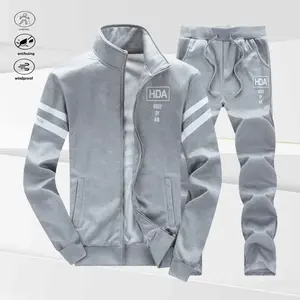 A set of men's stand collar outfits, featuring a simple casual style with white striped decoration on the top and "HDA HOOD BY AIR" printed on the chest. The pants also bear the brand logo, showcasing an overall stylish and elegant design.