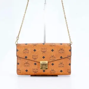 Pre-owned MCM medium envelope bag with chain strap, brandy color