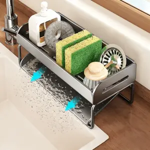 A Sponge Holder for The Kitchen Sink Made of Rust-Proof Carbon Steel, Featuring a Drainage System, a Soap Dispenser, And a Space for Sponges. This Countertop Storage Rack Is Designed for Kitchen Use And Comes in a Grey Color, Dish Drying Organiser