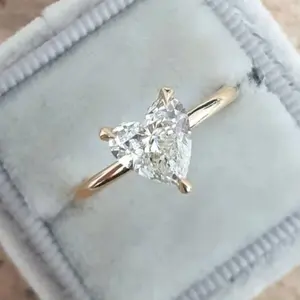 This women's engagement ring is made of 14k gold, features a simple design, and is set with a Zirconia stone in a heart shape, suitable for everyday wear.