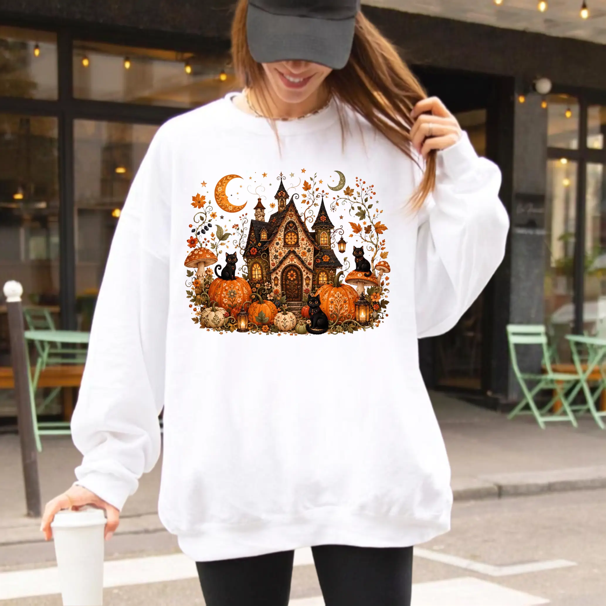 Haunted Cottage Sweatshirt , Whimsical Witch House With Black Cats Pumpkins Mushrooms And Crescent Moons Graphic Sweatshirt , Cottagecore Halloween Sweatshirt , Spooky Fall Outfit | GHINI