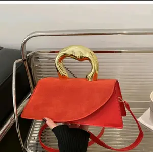 Elegant Red Suede Handbag with Gold Tone Handle and Adjustable Strap for Women