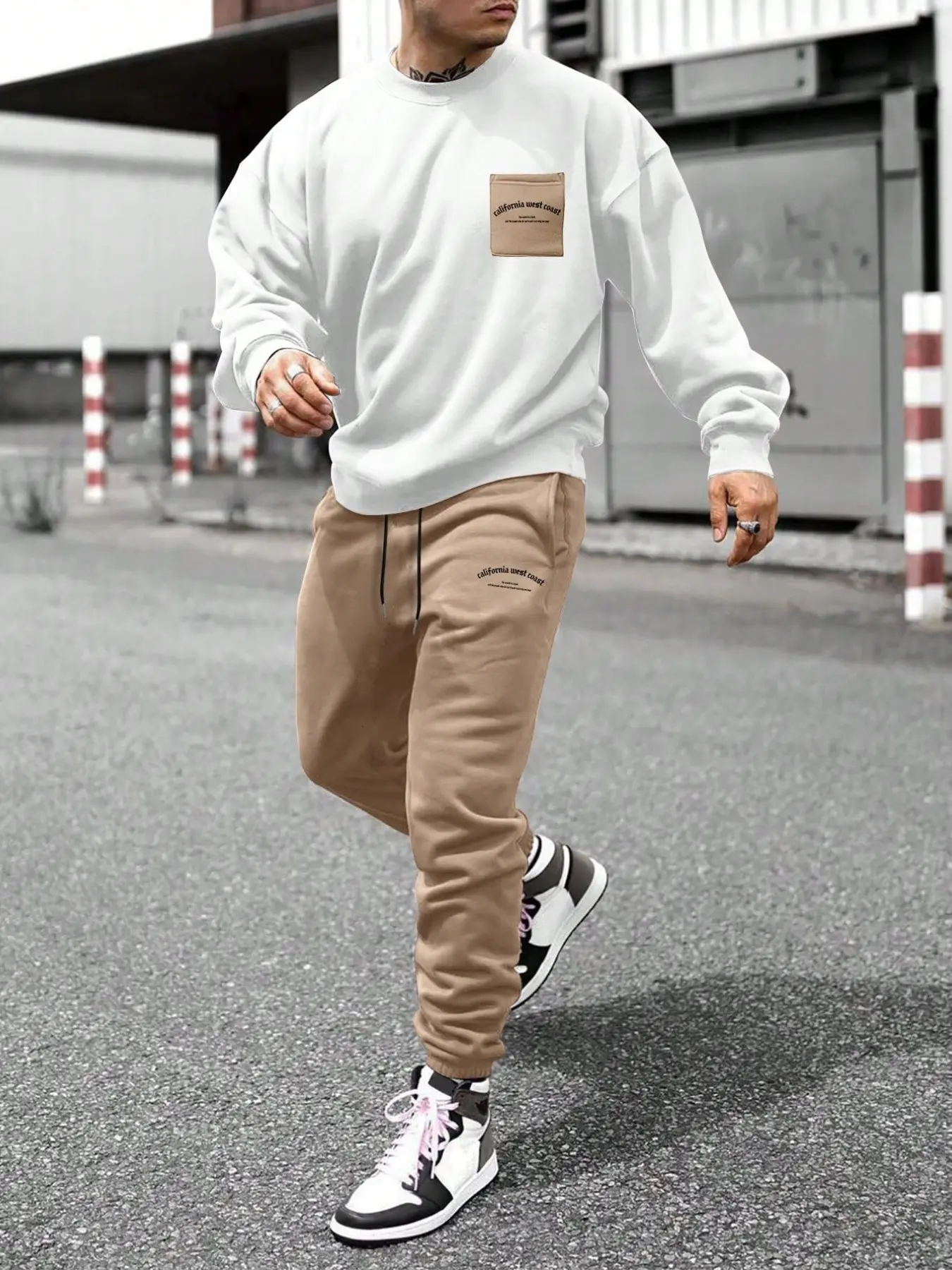 This men's two-piece set includes a white Graphic pullover and drawstring trousers. The casual style is suitable for everyday wear and makes a great gift for friends.