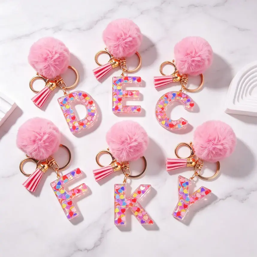 Pink Pom Pom 26 Letter Keychains, Resin Alphabet Key Chains Filled with Heart Glitter, Tassel Crystal Bag Charms. Perfect birthday, holiday and party gifts for friends and family.