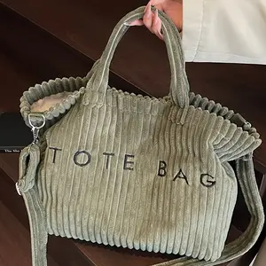 A Stylish Solid Color Corduroy Tote Bag for Women, Featuring a Letter Design And Contrasting Elements, with an Adjustable Shoulder Strap. This Versatile And Straightforward Crossbody Bag Is a Classic Square Shape, Ideal for Professional Settings