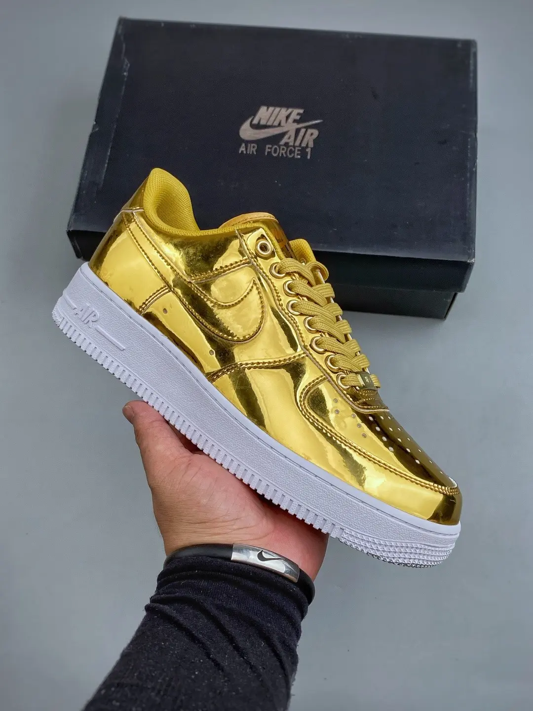 Low-top street sneakers built with shiny metallic gold upper, cushioned insole, crisp white rubber outsole for bold statement streetwear looks