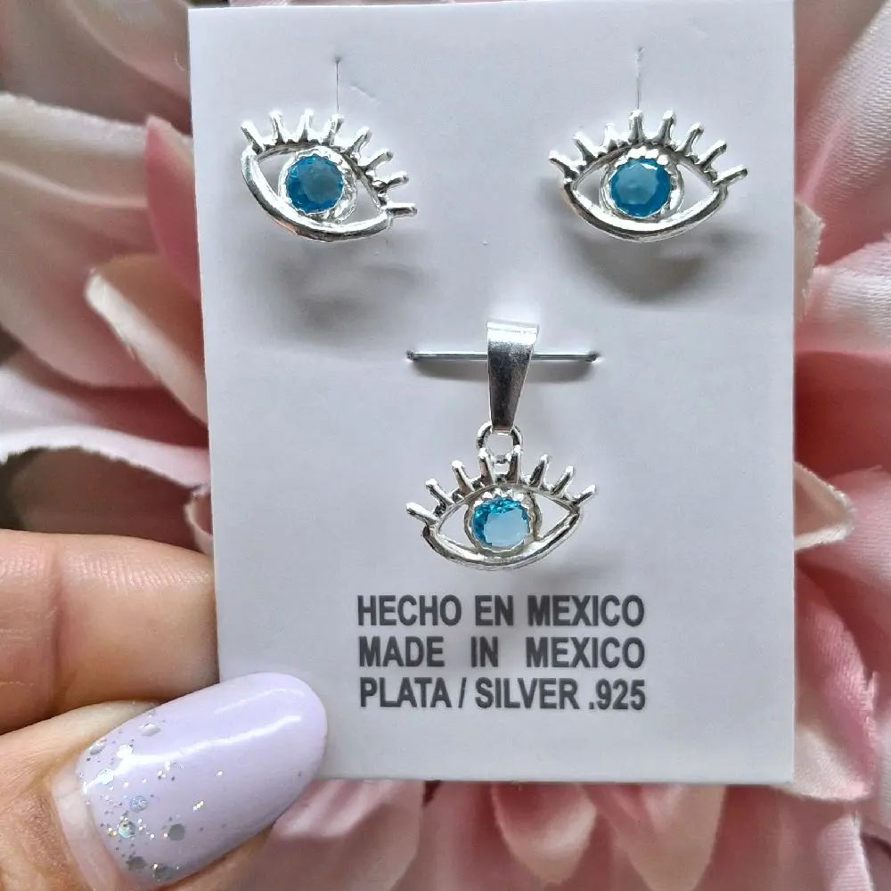 set de aretes y dige de ojito con zirconia celeste plata.925