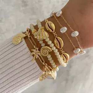 Women's 6-Piece Gold Layered Beach Bracelet Set - Cowrie Shell, Faux Pearl, Rhinestone Palm Tree, Conch, Whale Tail, Paperclip Charm Stackable Costume Bangles necklace