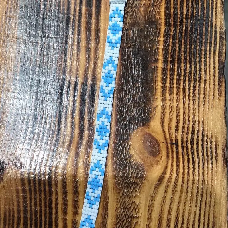 Beautiful Peyote Bracelet with Blue and White Patterned Design on Wooden Background