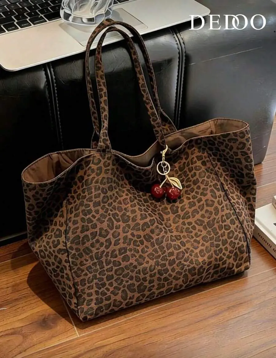 Large Capacity Women's Brown Tote Bag With Red Cherry Pendant. Featuring Leopard Print Design And Sturdy Dual Top Handles For Shoulder Or Hand Carry. Suitable For Storing Daily Essentials Such As Lipstick, Keys, Water Bottle, Umbrella, Cosmetics,