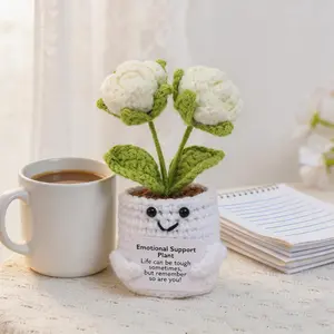 A small, handcrafted crochet potted plant featuring a double-headed rose—accompanied by an emotional support card. This warm, soft desktop ornament makes for a lovely little gift for friends and family.