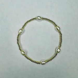 The Pearly Gold Bracelet This stretchy bracelet is a beautiful accessory that can be worn comfortably on any wrist size. The bracelet is made with 3mm gold plated hematite gem stone beads that add a touch of elegance to the design.  The bracelet also feat