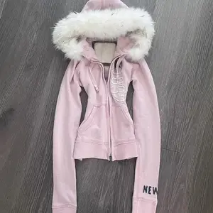Retro American pink faux fur hooded sweatshirt with a waist-cinching design, Y2K cut, that can pair with a raincoat instead of outerwear GARMENTARY