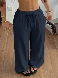 Women’s ultra-comfortable casual long pants made from polyester fiber, featuring side pockets, a drawstring elastic waistband, soft fabric, and drapey cuffs—an essential for summer.