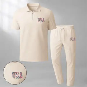 Men's classic two-piece set—featuring a short-sleeve polo shirt with a zip collar and "USA" logo, paired with matching trousers—is crafted from breathable, soft-textured waffle-knit fabric. Designed with a relaxed fit, it is ideal for everyday casu