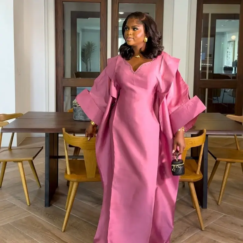 Akwaugo dress made with high quality mikado fabric embellished with crystals design on the neck with a bold love shape sleeve, one size fits all dress