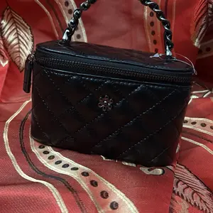 Elegant Black Quilted Vanity Handbag with Mirror, Adjustable Chain Strap, and Zipper Closure