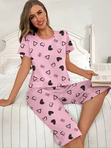 Pink & heart printed pajama set, featuring a short-sleeved round-neck top and elastic-waist cropped pants, with a sweet "LOVE" letter design – perfect for women's sleepwear and Cute Pajama Sets