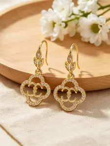 A pair of openwork flower earrings, delicate four-leaf clover earrings, and luxurious copper earrings inlaid with zircon