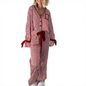 Women’s striped pajama set featuring a long-sleeve button-up crop top and bow-adorned long pants; breathable two-piece sleepwear outfit for cozy winter nights and Christmas holiday lounging. Valentine’s Day red polyester women’s pajamas.
