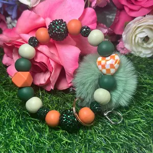 Sweet sage wristlet keychain  color scheme green, sage green, burnt orange and bling beads made with wire