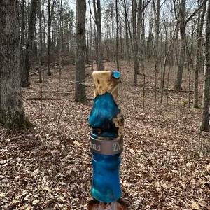 Custom duck call made from blue resin with buckeye burl wood