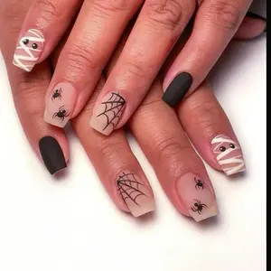 Spooky press on nails. Short, square, and matte press on with spider, spiderweb, mummy, and black designs.