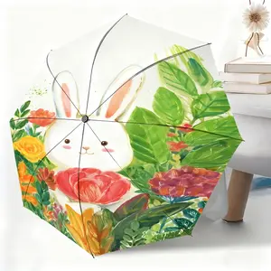 A waterproof folding umbrella with a cartoon illustration of a white rabbit holding flowers. Suitable for both men and women, it's portable and perfect for travel and everyday use.