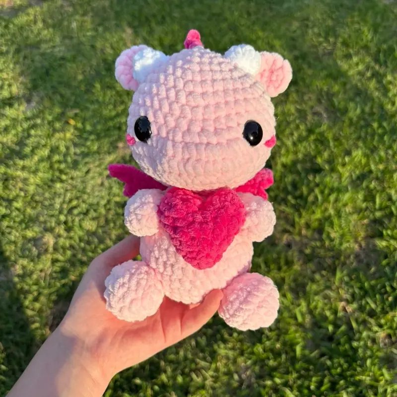 Handmade Crochet Pink Baby Dragon Plushie, Kawaii Collectible Holding a Heart, Handmade Gifts for Plushie Enthusiasts