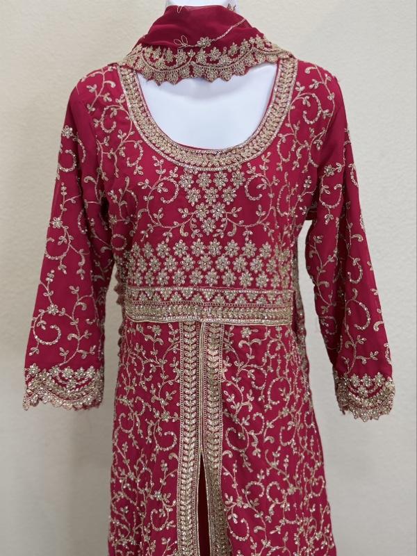 This image shows a green designer heavy embroidered bridal lehenga or Anarkali suit suited for traditional Indian weddings. Womenswear