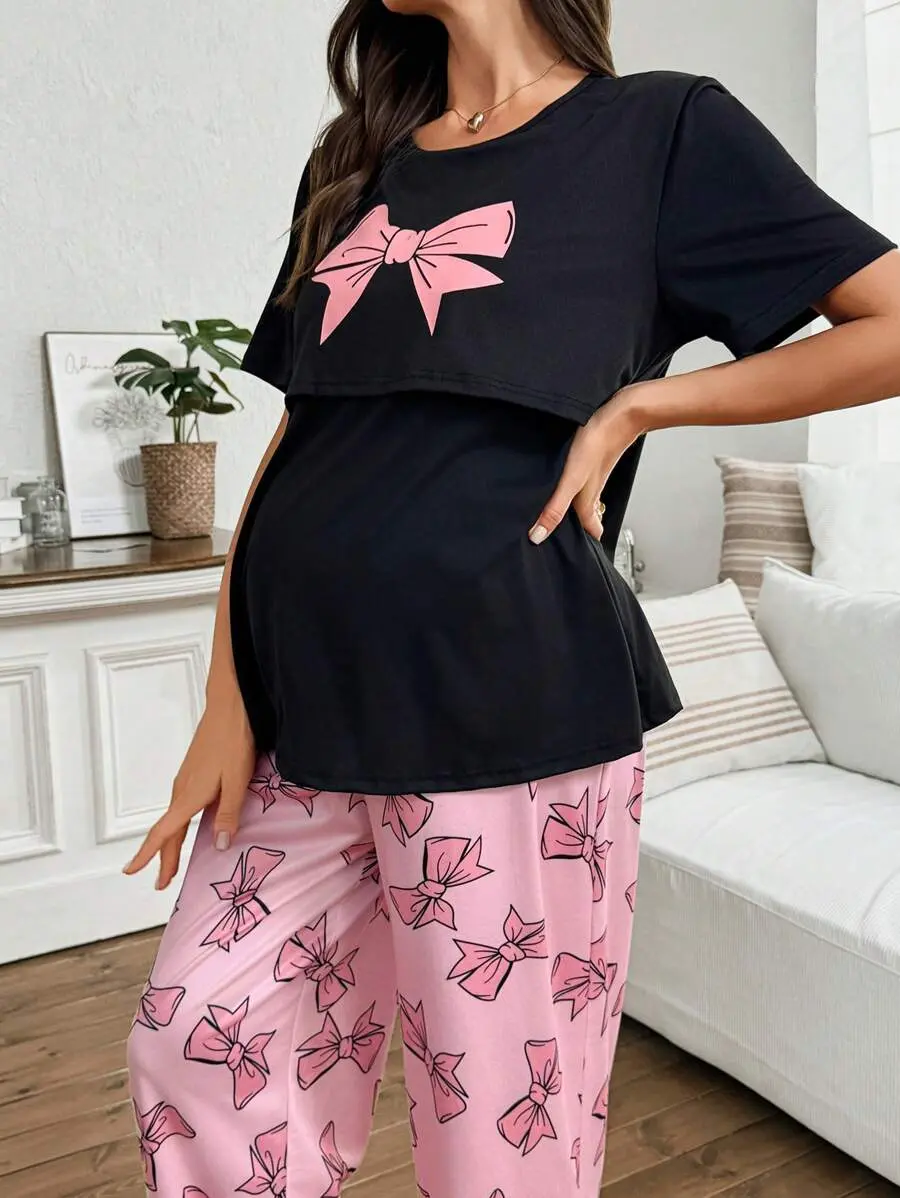 Women's Maternity & Nursing PJS.Black Short Sleeve Round Neck Top Features A Pink Bow And Pairs With Matching Long Pink Pants For Casual Sleepwear.