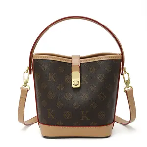 The Iconic Bucket Bag - Signature Leather Lock Strap & Adjustable Crossbody - Timeless Bucket Shape with Premium Leather Details - Women's Crossbody Bag