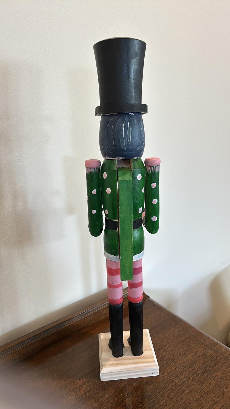 Hand-painted wooden nutcracker. He measures 24 inches tall. “Gunner” is a handsome guy that absolutely can live in your space year round.