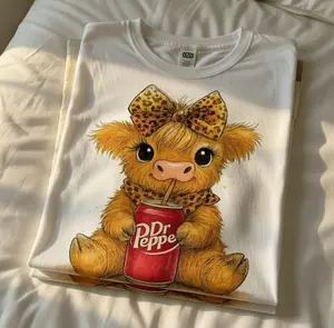 [SALE UP TO 50%] Cute Highland Cow Dr Pepper Sweatshirt / T-Shirt / Hoodie – Adorable Baby Cow Drinking Soda Graphic with Leopard Bow, White Cozy Kawaii Style, Gift for Cow Lovers