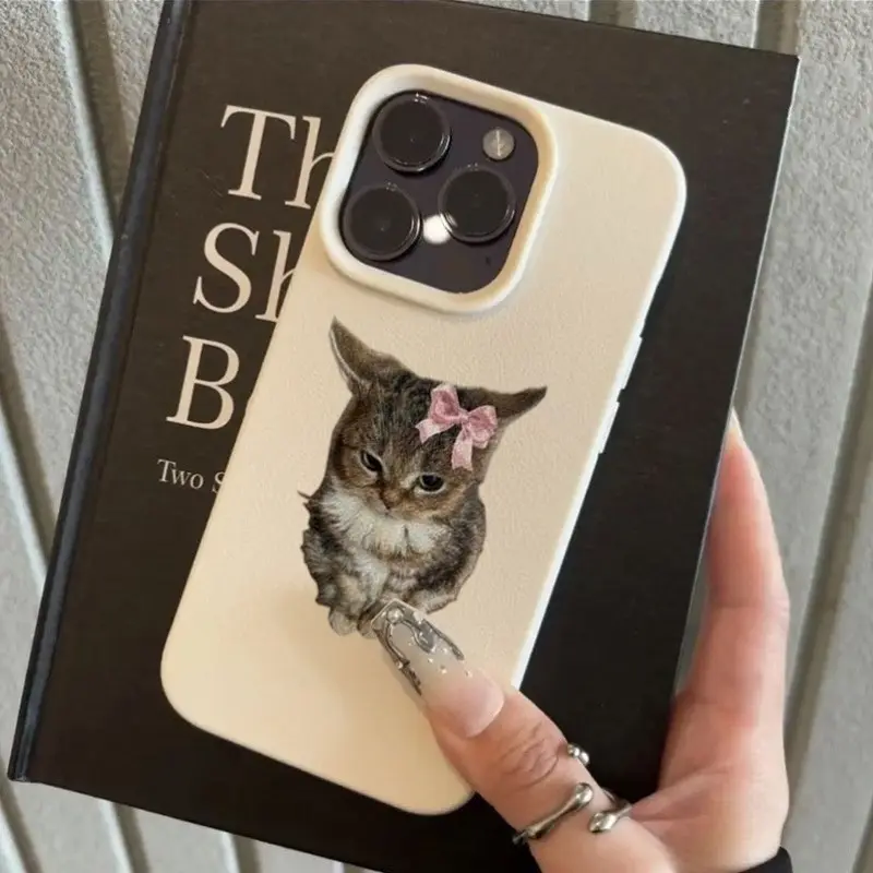 Mood In Case catalog image of a centered fluffy gray kitten portrait wearing a pink bow on a pale phone case