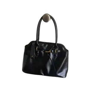 A casual handbag with a magnetic clasp closure/single shoulder strap. It has ample capacity and features various strap designs, making it suitable for women.