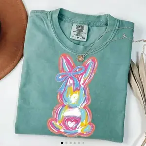 Easter Comfort Colors shirt featuring a cute raccoon Easter bunny design, funny and playful crewneck style, a Happy Easter Day gift for women.