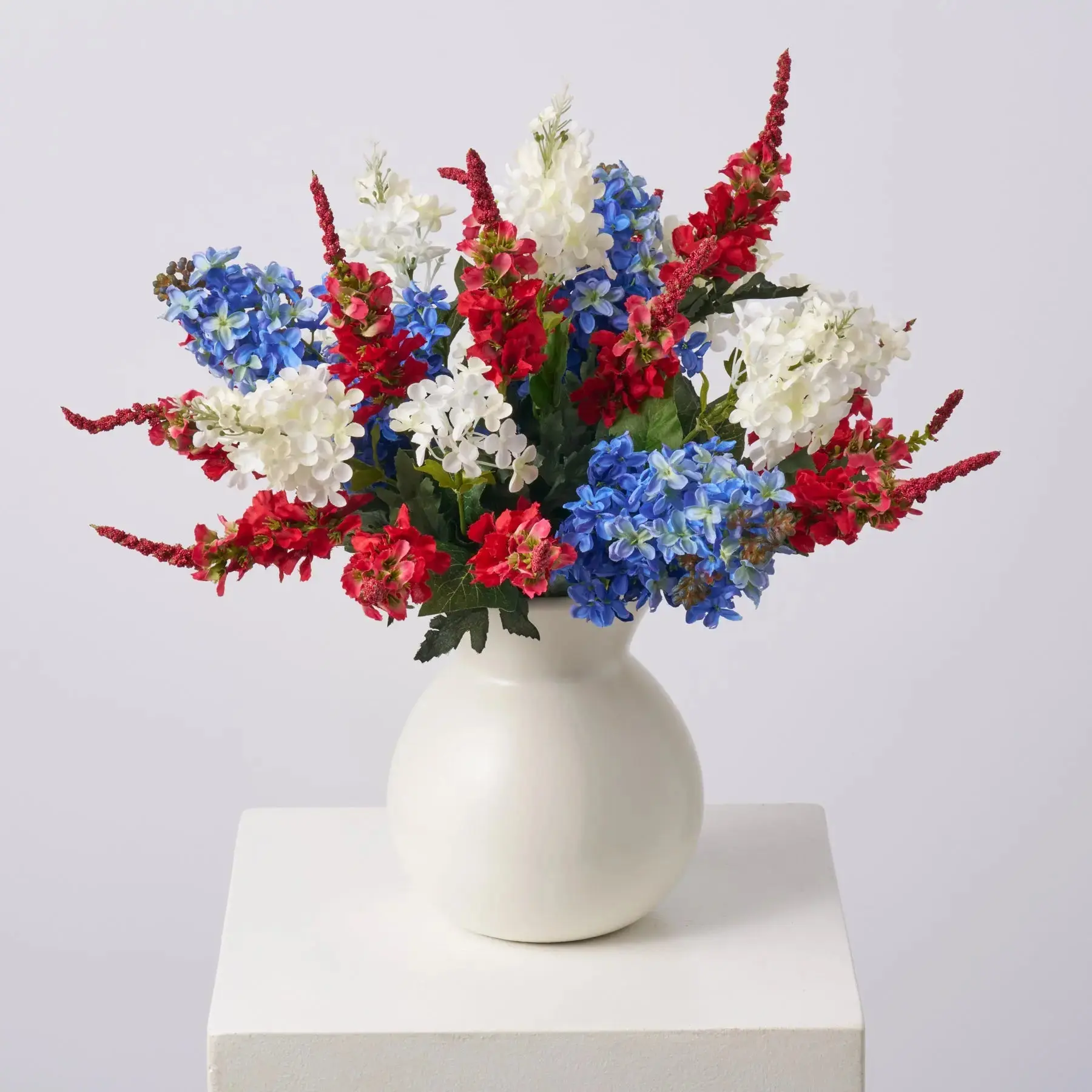 Floral Patriotic Artificial Flower Arrangement Centerpiece - Red Delphinium, White Lilac, Blue Hyacinth in Matte Cream Vase for Home Room Decor, Floral Arrangement Centerpiece