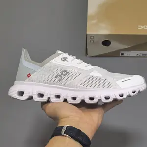 Retro running sneakers with flexible segmented shock-absorbing athletic silhouette, premium breathable knit mesh finished in pale mist gray paired with pastel pink hollow midsole accents, grippy hollow foam midsole
