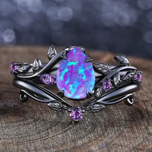 A set of two matte black silver-plated rings set with purple synthetic opal stones in pear and leaf patterns, suitable for festivals, parties, everyday wear, and as gifts for friends and family.