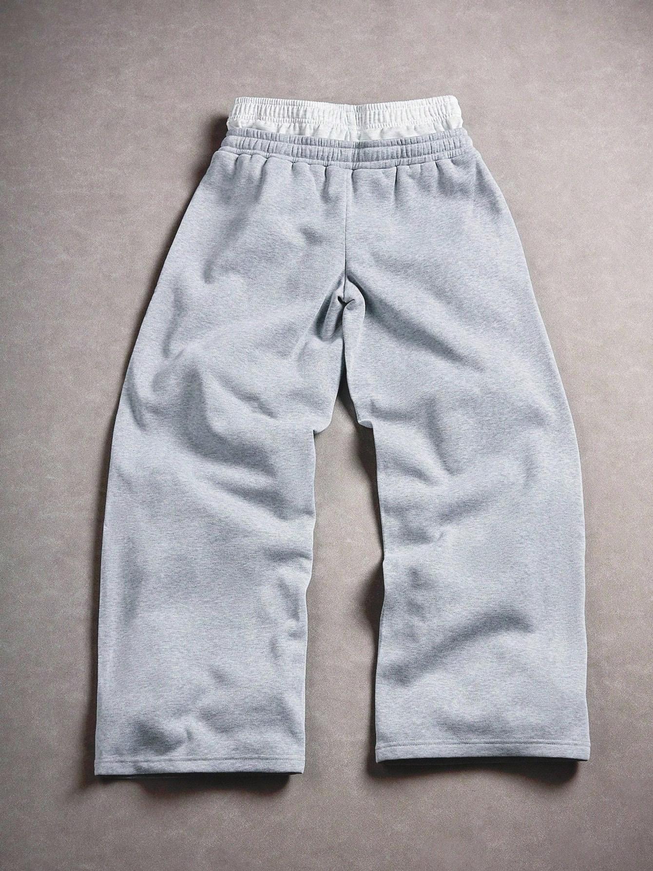 Gray sweatpants with embroidered logo, Y2K American street casual joggers, loose casual knitted sports pants featuring a drawstring and faux two-piece design with contrasting double waistband, perfect for everyday wear and trendy gatherings.