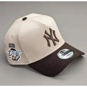 9FORTY New York World Series Side Patch Baseball Cap – Cream & Brown, Adjustable Size, Brown NY Logo, moda urbana para hombres y mujeres, ideal para destacar tu estilo en TikTok 2026